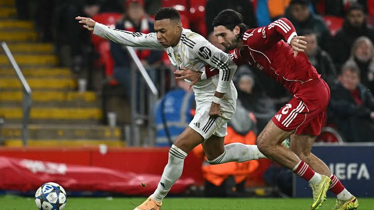 Liverpool's Dominik Szoboszlai in a tussle with Real Madrid's Kylian Mbappe